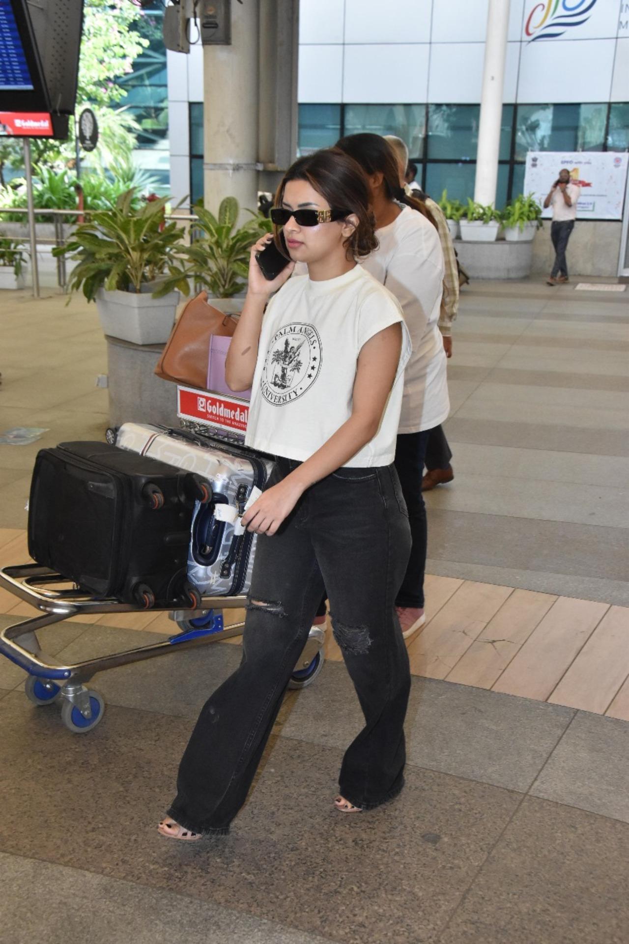 Avneet Kaur was wearing a white crop top with a gray pair of slacks, and she appeared engrossed in a phone conversation as she departed the airport